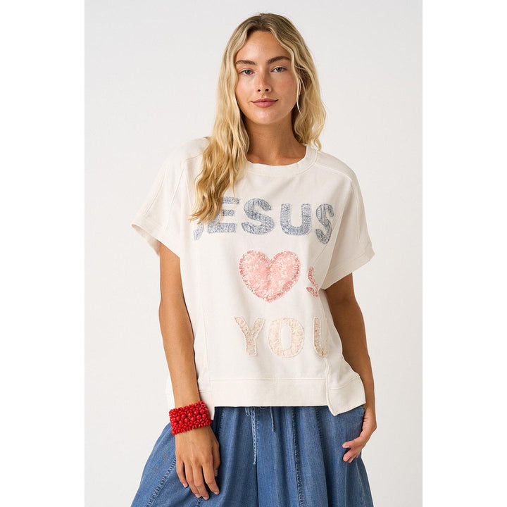 Mittoshop White Knit top featuring "Jesus Loves You" lettering patchwork, short sleeves, and a relaxed fit.