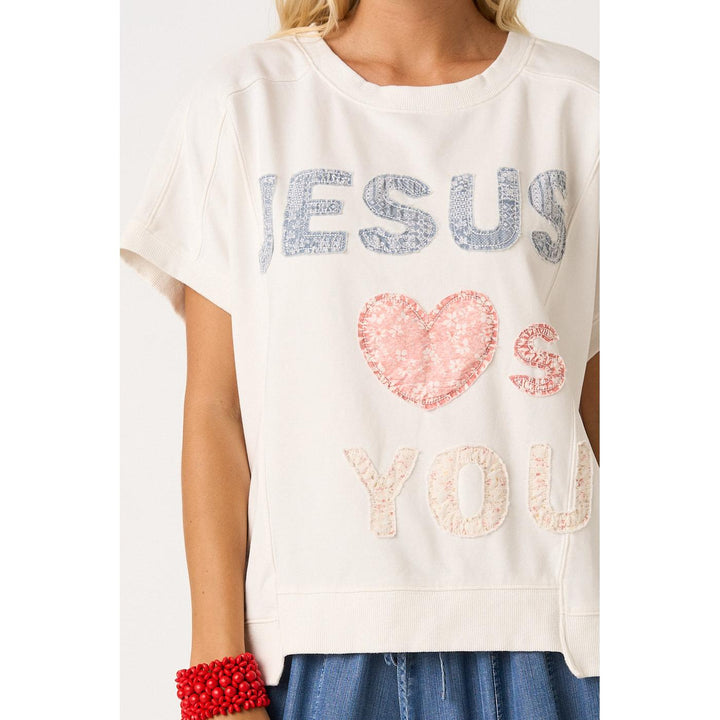 Mittoshop White Knit top featuring "Jesus Loves You" lettering patchwork, short sleeves, and a relaxed fit.