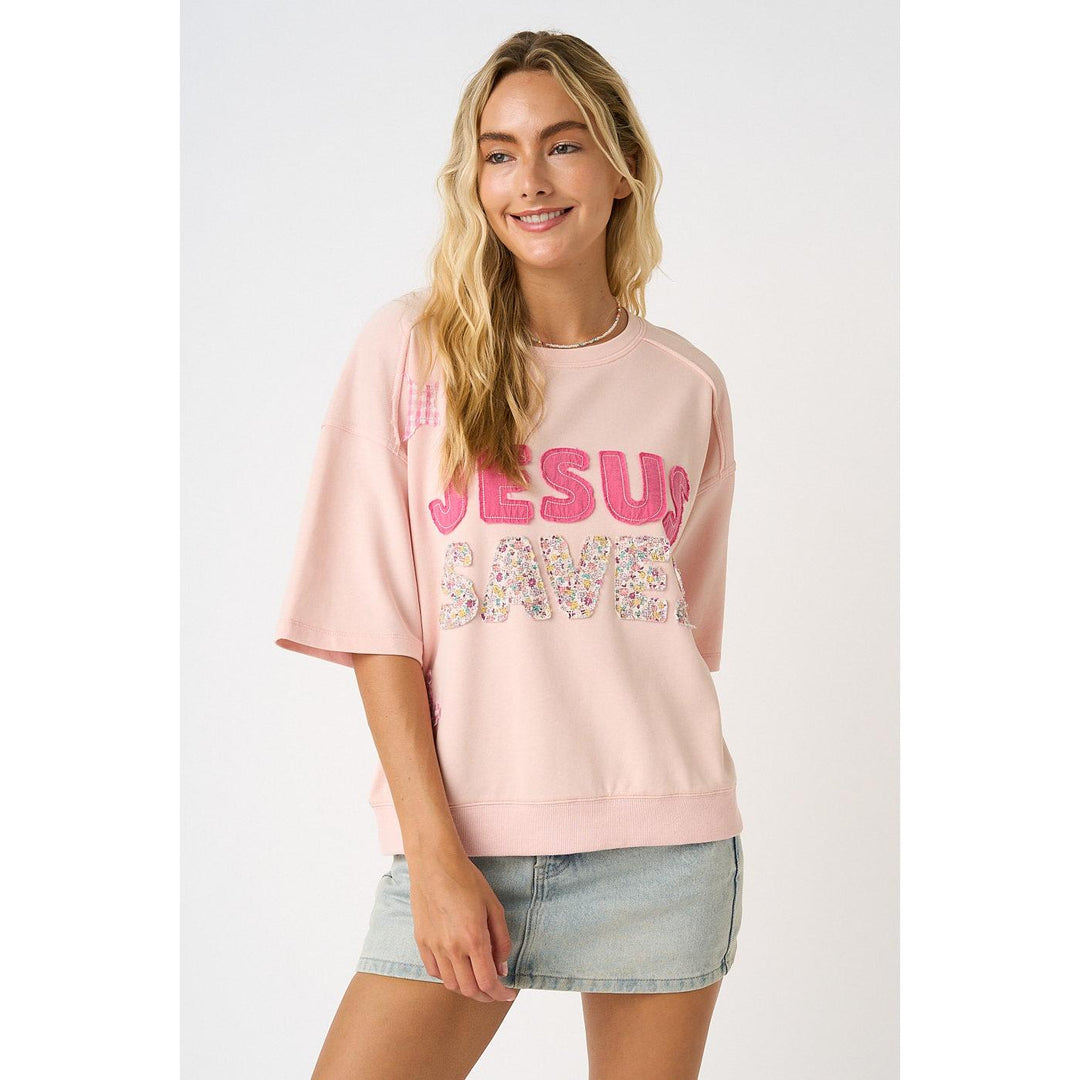 Mittoshop Icy Pink Knit Top featuring "Jesus Saves" lettering, star patches, and floral patchwork details.