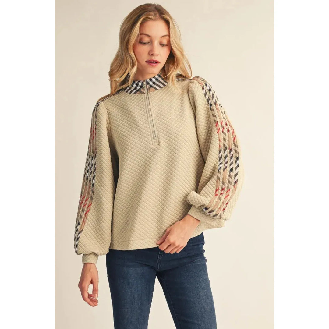 Model wearing the beige Jodifl Quilted Long Sleeve Top featuring puff sleeves and plaid contrast detail.