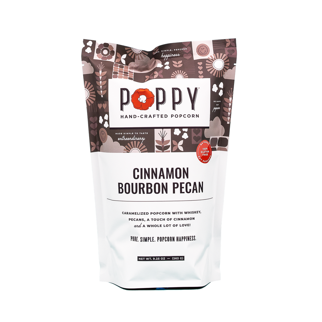 Poppy Hand-Crafted Cinnamon Bourbon Pecan gourmet popcorn in a classic artisanal brand market bag alongside whole pecans.