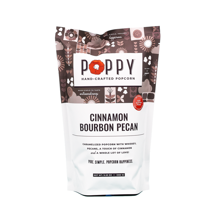 Poppy Hand-Crafted Cinnamon Bourbon Pecan gourmet popcorn in a classic artisanal brand market bag alongside whole pecans.