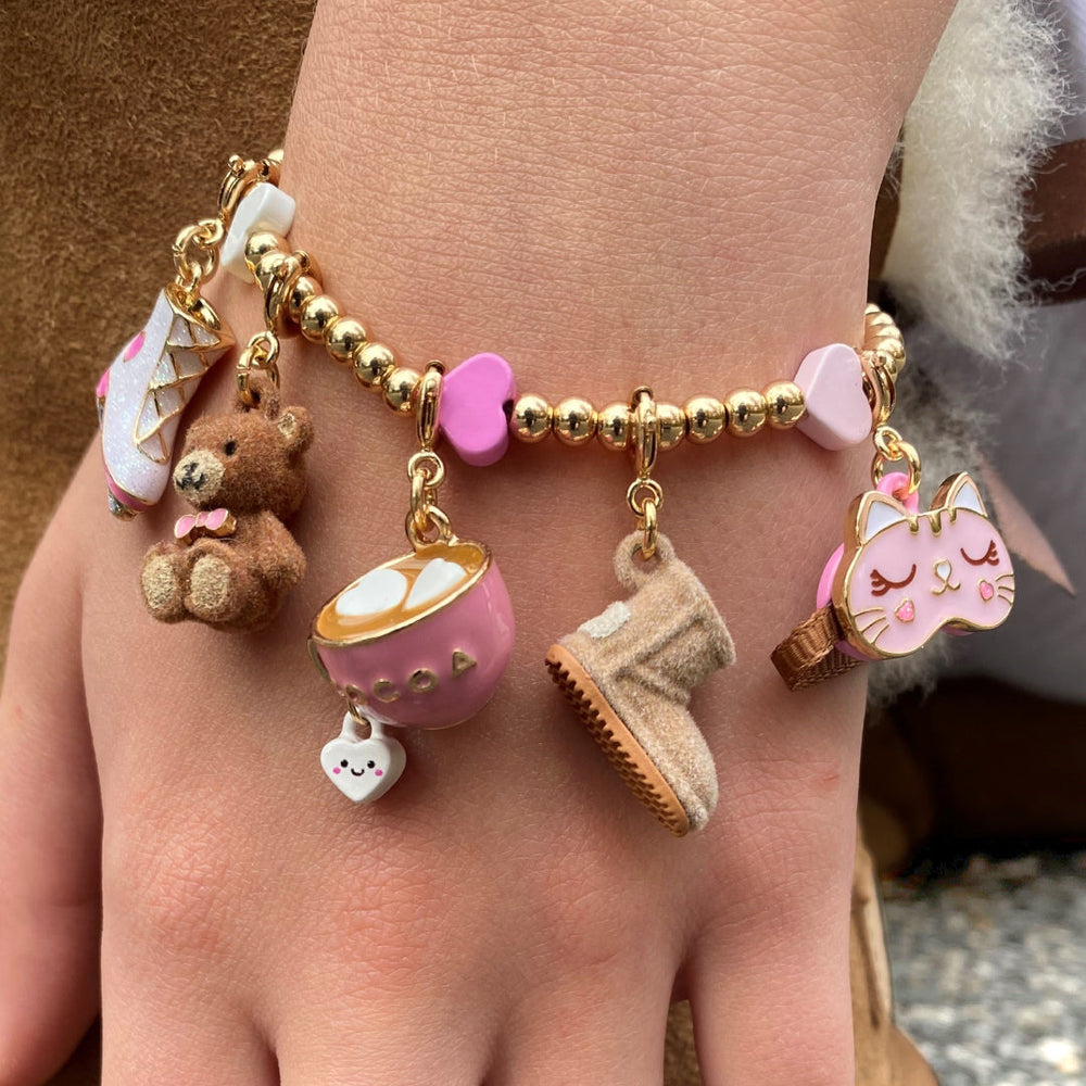 Charm It Gold Fuzzy Bear charm in the cozy collection on a kids charm bracelet