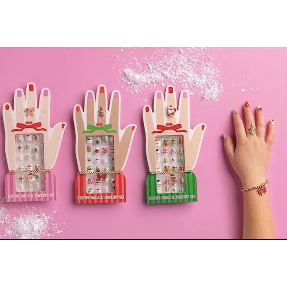 Mud Pie Christmas nails and jewelry 3-piece sets displayed on hand-shaped cards, available in red, pink, and green.