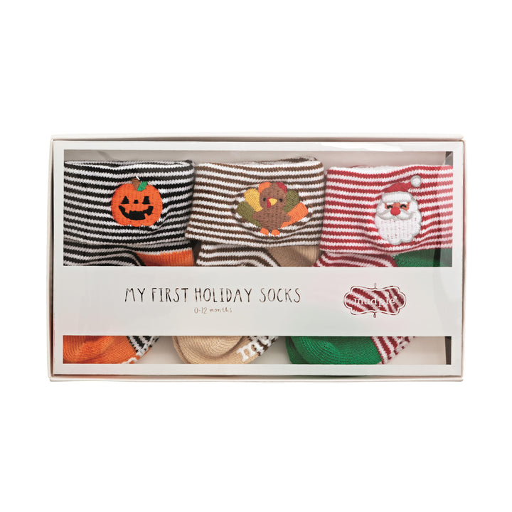 Mud Pie set of three pairs of cotton baby socks featuring Halloween, Thanksgiving, and Santa embroidery at the ankle cuffs.