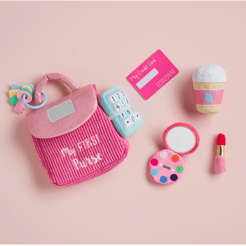 Close-up of the plush lipstick and ringing phone accessories from the My First Purse interactive set.