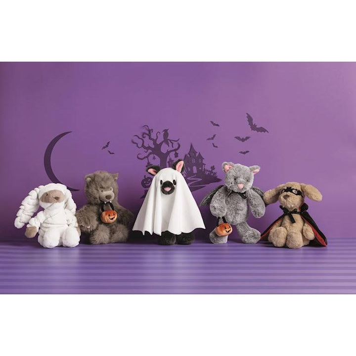 Assortment of Mud Pie Trick-Or-Treat cuddly plush animals in Halloween costumes including a Mummy, Werewolf, Ghost, and Vampire.