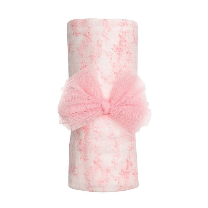 Mud Pie 2-piece set featuring a rolled pink toile muslin swaddle blanket and a coordinating pink mesh bow headband.