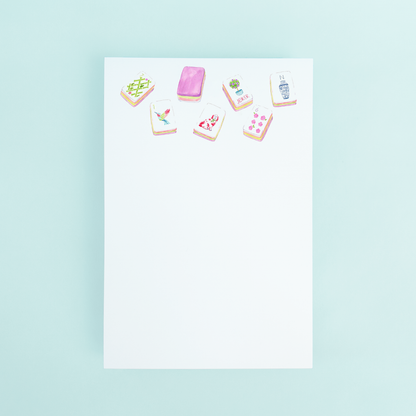 Watercolor illustration of colorful Mahjong tiles at the top of a white 4x6 notepad by Taylor Paladino.