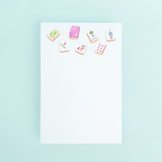 Watercolor illustration of colorful Mahjong tiles at the top of a white 4x6 notepad by Taylor Paladino.