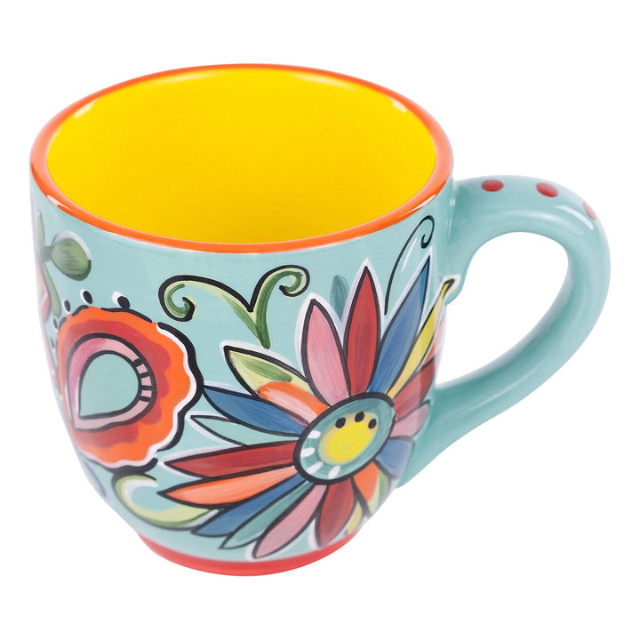 Glory Haus hand-painted 16oz coffee mug featuring a bright turquoise floral design with a yellow interior.