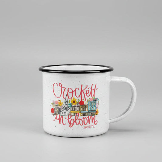 White mug with decorative text and graphics on a beige surface
