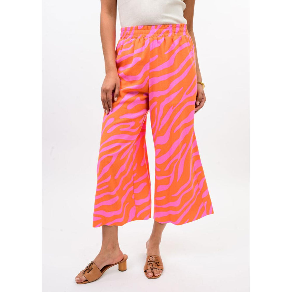 The wide-leg silhouette and cropped hem of the Ivy Jane Tangerine zebra print pants.