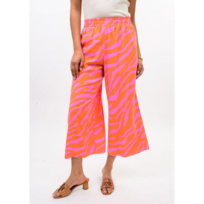 The wide-leg silhouette and cropped hem of the Ivy Jane Tangerine zebra print pants.