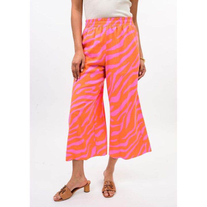 The wide-leg silhouette and cropped hem of the Ivy Jane Tangerine zebra print pants.