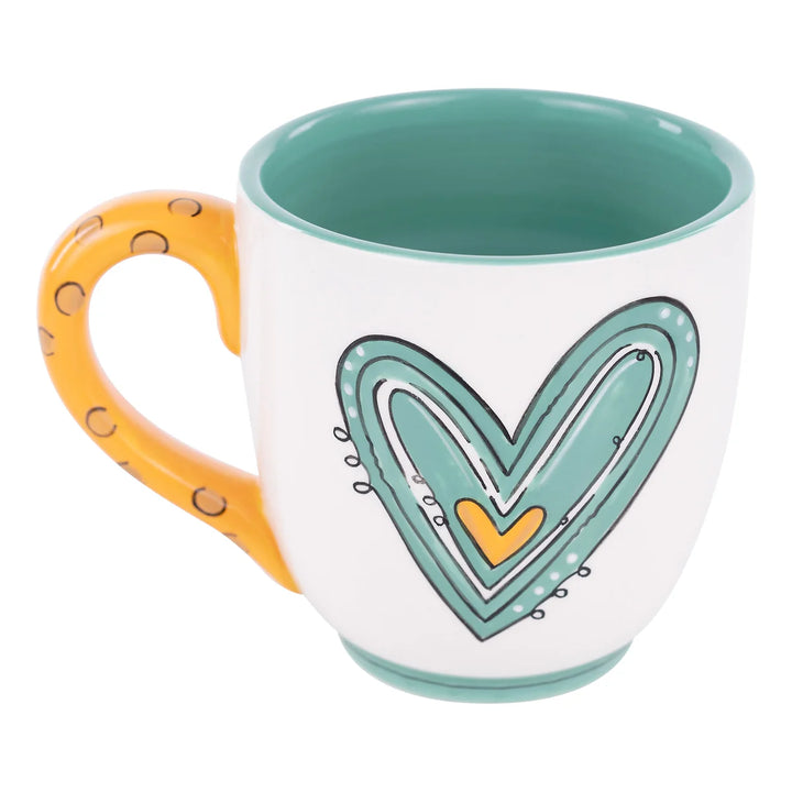 Close-up of the heart pattern and "Best Mom Ever" text on a Glory Haus ceramic mug