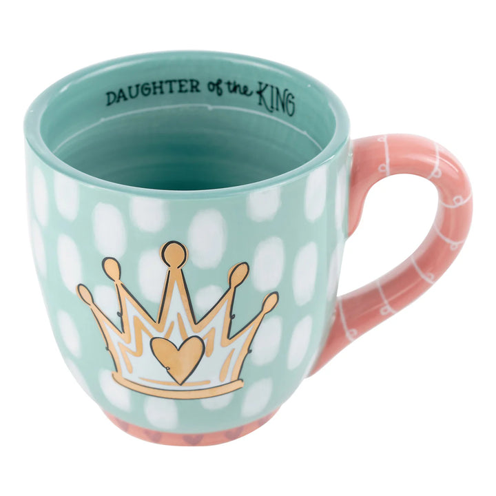 Hand-painted 16 oz "Daughter of the King" ceramic mug featuring a golden crown and floral base.