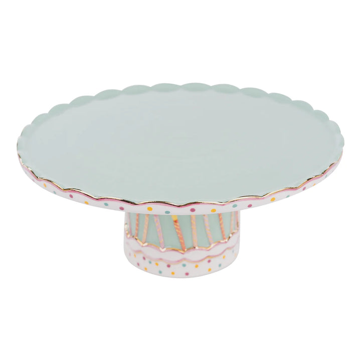 Hand-painted Glory Haus ceramic cake stand with festive birthday candle patterns around a sturdy round base.