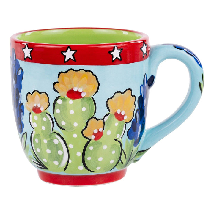 Glory Haus hand-painted 16oz coffee mug featuring Texas wildflowers, cacti, and red trim.