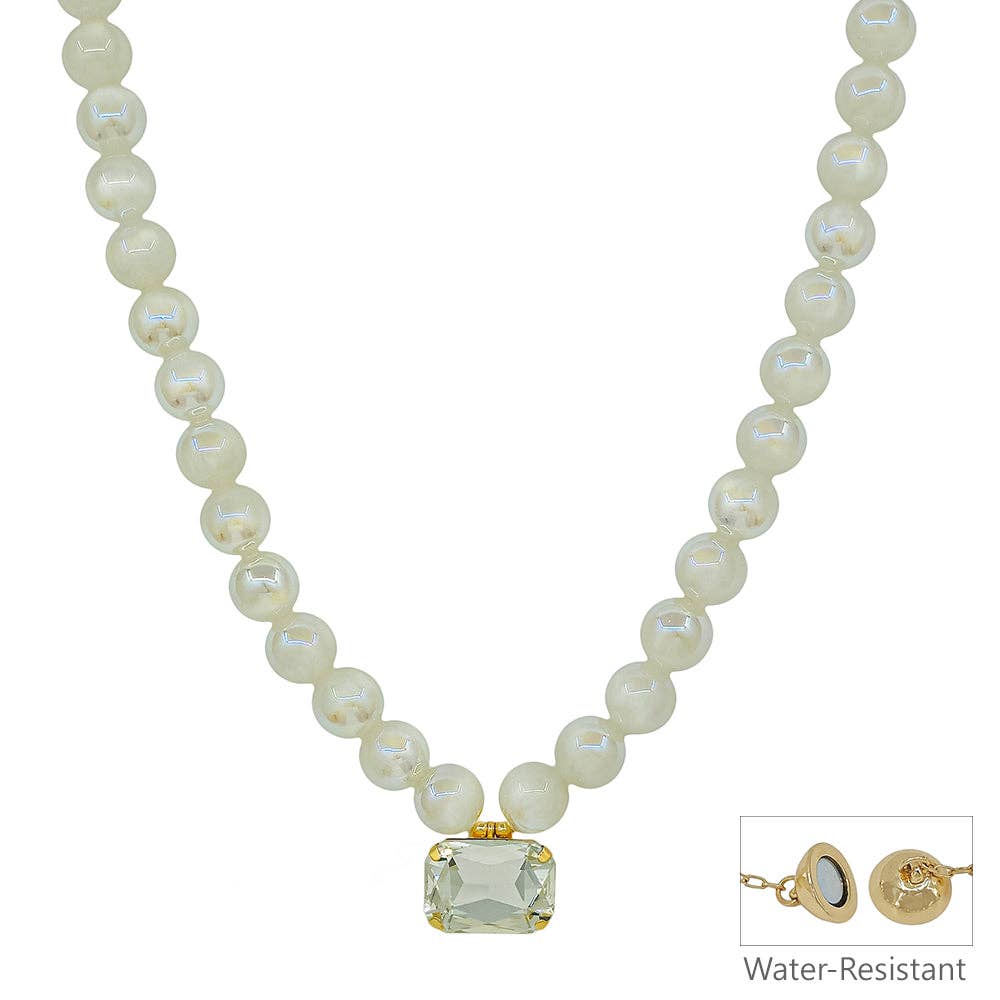 Pearl necklace with a gold clasp on a white background