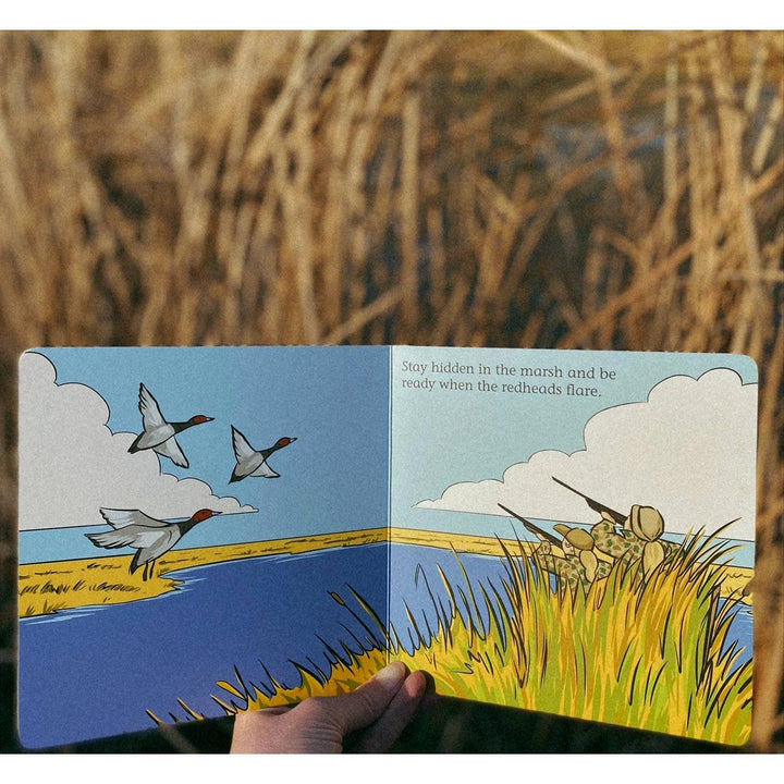Waterfoul with redheads flyng and hunters in the marsh hiding