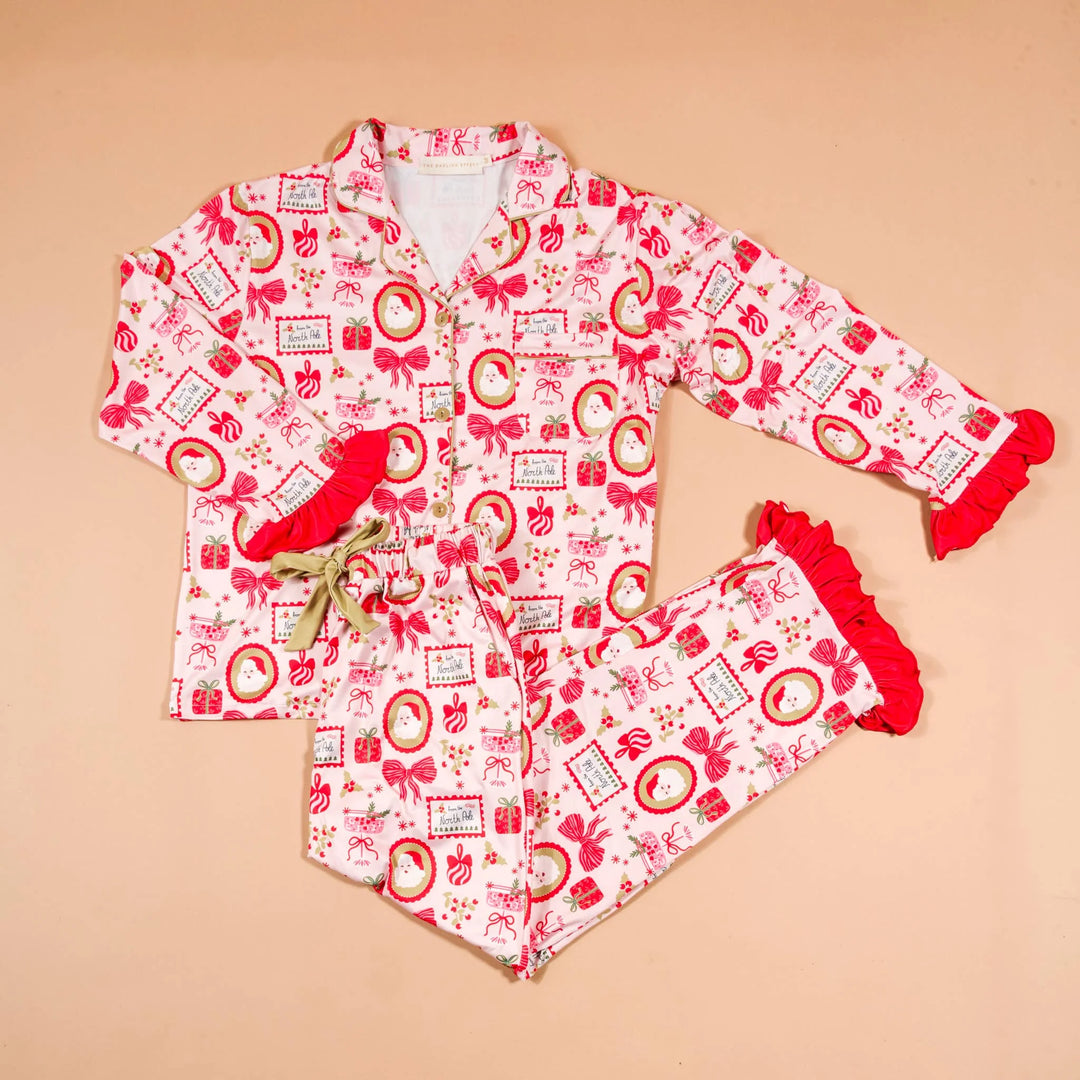 The Darling Effect Mistletoe Magic Pajama Set featuring a festive holiday print on a long-sleeve top and pants.