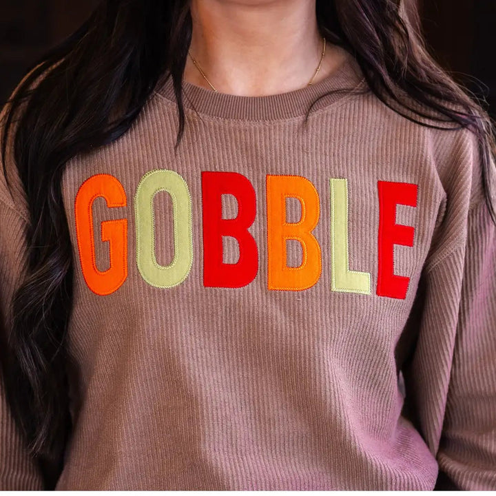 Spirit to a Tee brown cozycord crewneck sweatshirt featuring the word "Gobble" in textured tackle twill lettering.