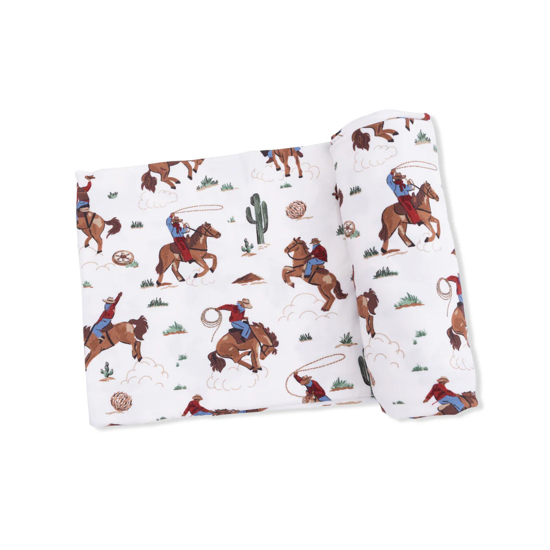 Infant bamboo swaddle blanket with Buckaroo Western print featuring cowboy boots and hats.