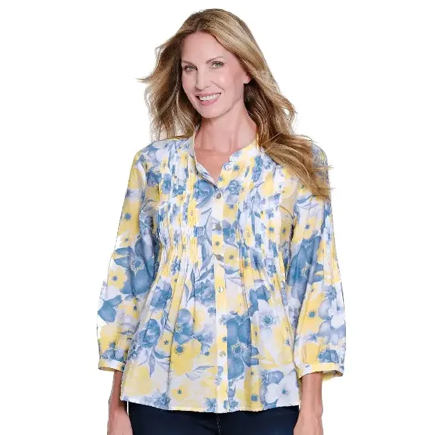 A woman wearing the Multiples M16511BM 3/4 sleeve floral blouse featuring a band collar and multi-tuck pleat details in yellow and blue.