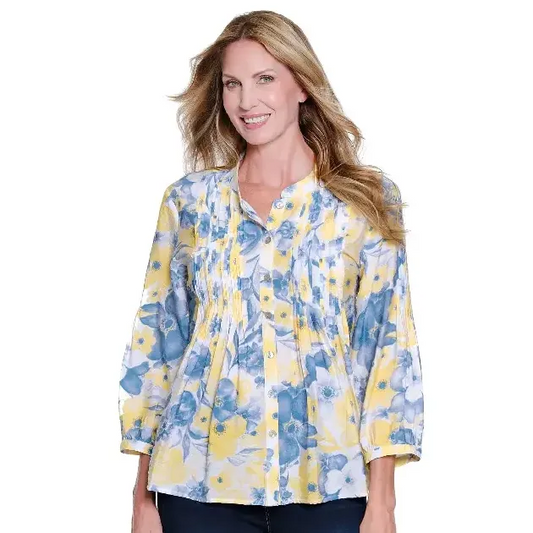 A woman wearing the Multiples M16511BM 3/4 sleeve floral blouse featuring a band collar and multi-tuck pleat details in yellow and blue.