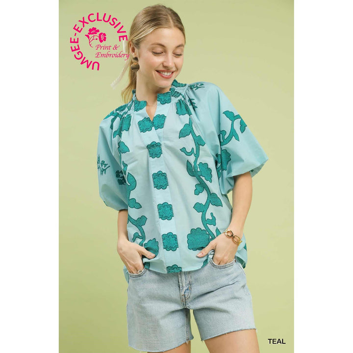 Front view of woman wearing Umgee teal print smocked collared summer top.