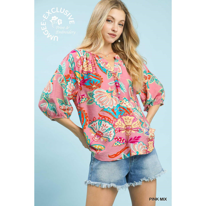 Woman modeling the flowy Umgee Paisley Print V-Neck Top in Pink Mix, featuring 3/4 sleeves with elastic cuffs and a gathered V-neckline.
