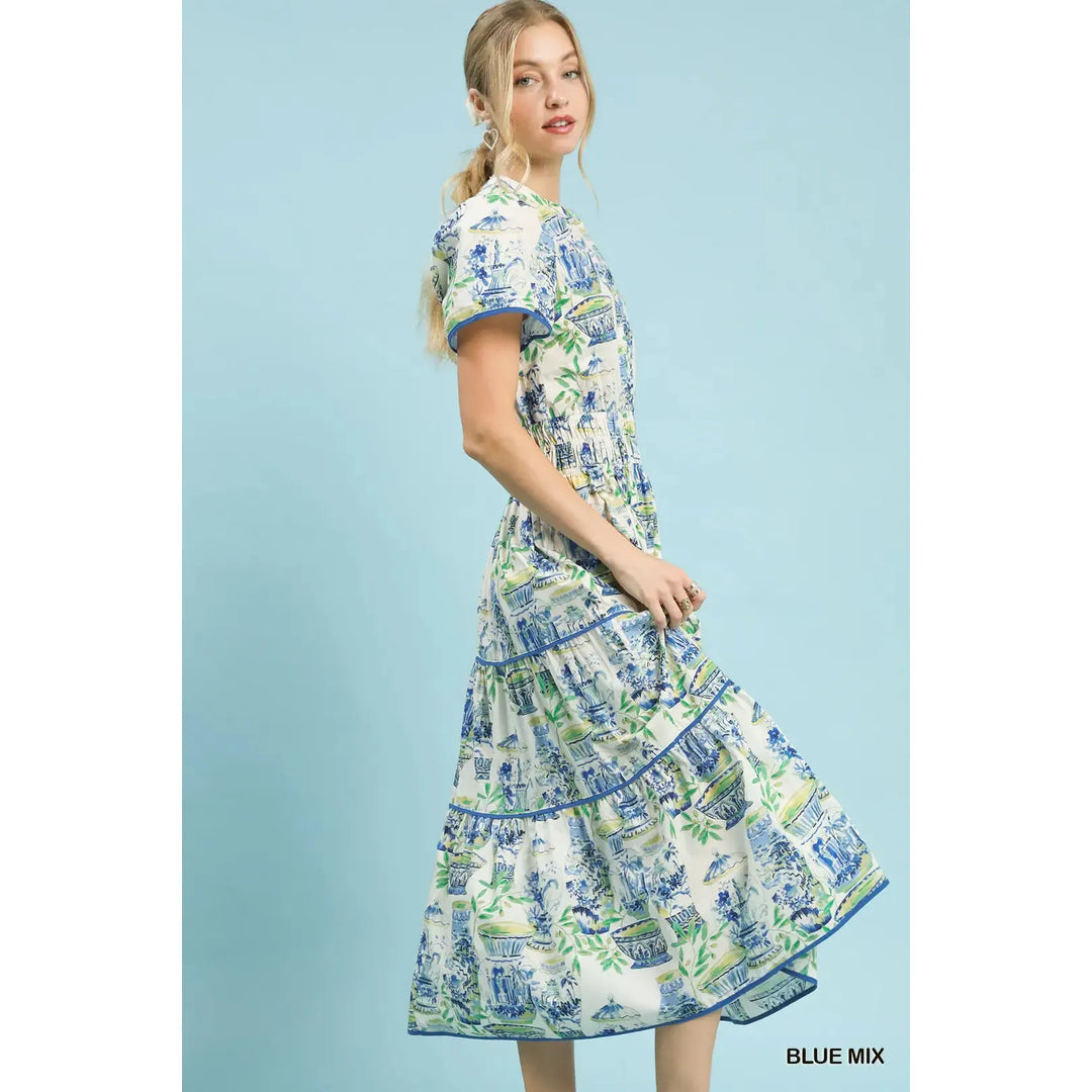 Side view of the Genevieve midi dress showing the smocked waist and puff sleeve detail.