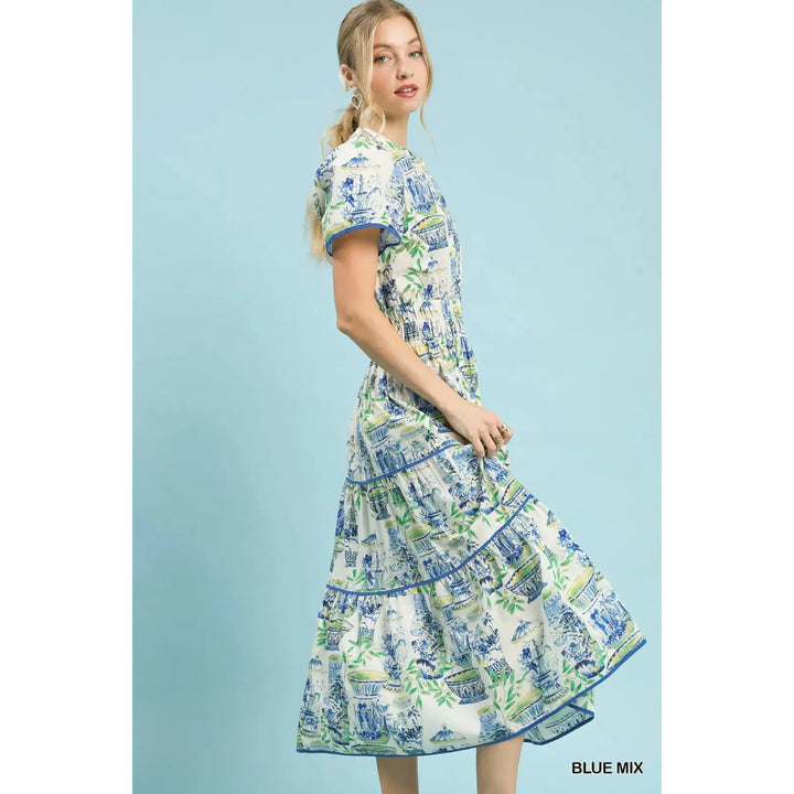 Side view of the Genevieve midi dress showing the smocked waist and puff sleeve detail.
