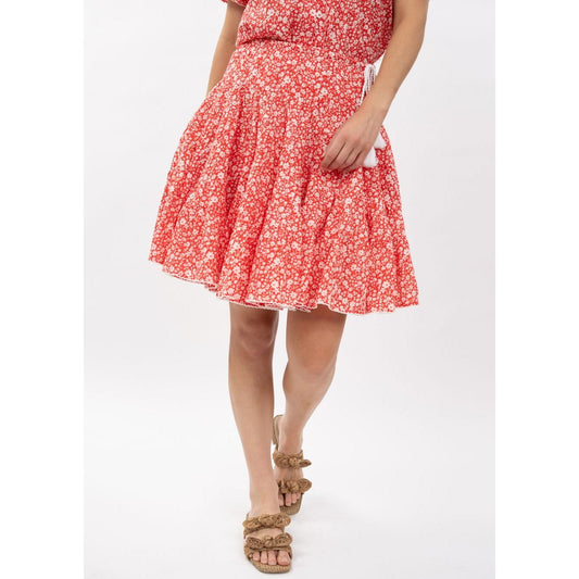 Model wearing the Ivy Jane Rosie red floral tiered skirt with tassel ties, Spring 2026 boutique fashion.