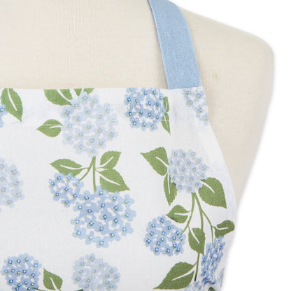 Close-up of the botanical hydrangea pattern on a cotton apron, highlighting the reinforced stitching on the deep front pocket.