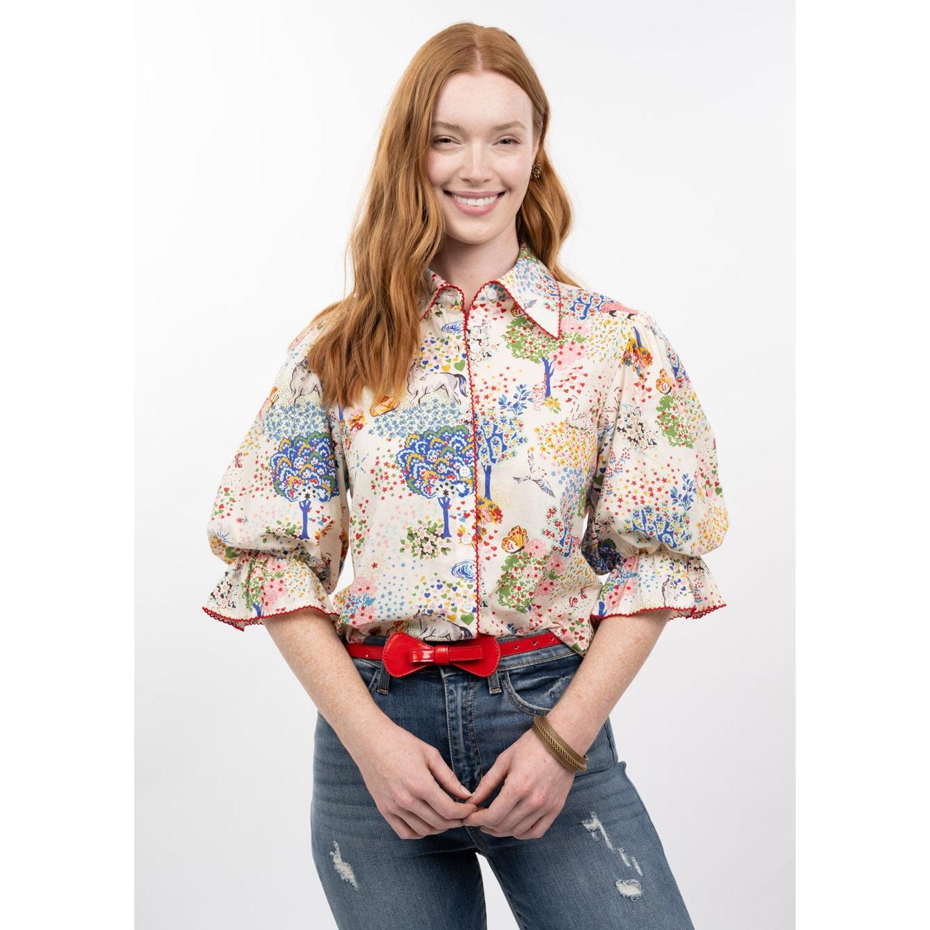 Woman wearing a colorful floral blouse with a white background