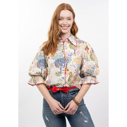 Woman wearing a colorful floral blouse with a white background