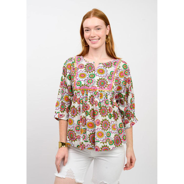 Ivy Jane Abundant Colors Top featuring a multi-color floral print, smocked bodice, and puff sleeves.