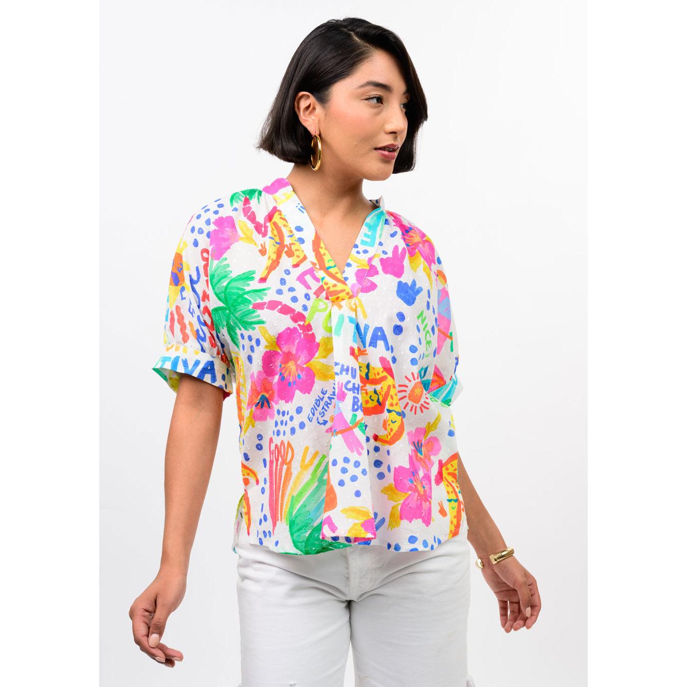 Close-up of the pointed collar and colorful watercolor-inspired print on the Ivy Jane dolman blouse.
