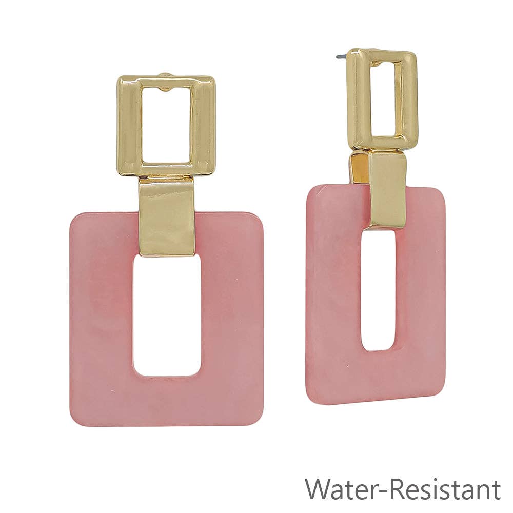 Pink square earrings with gold accents on a white background