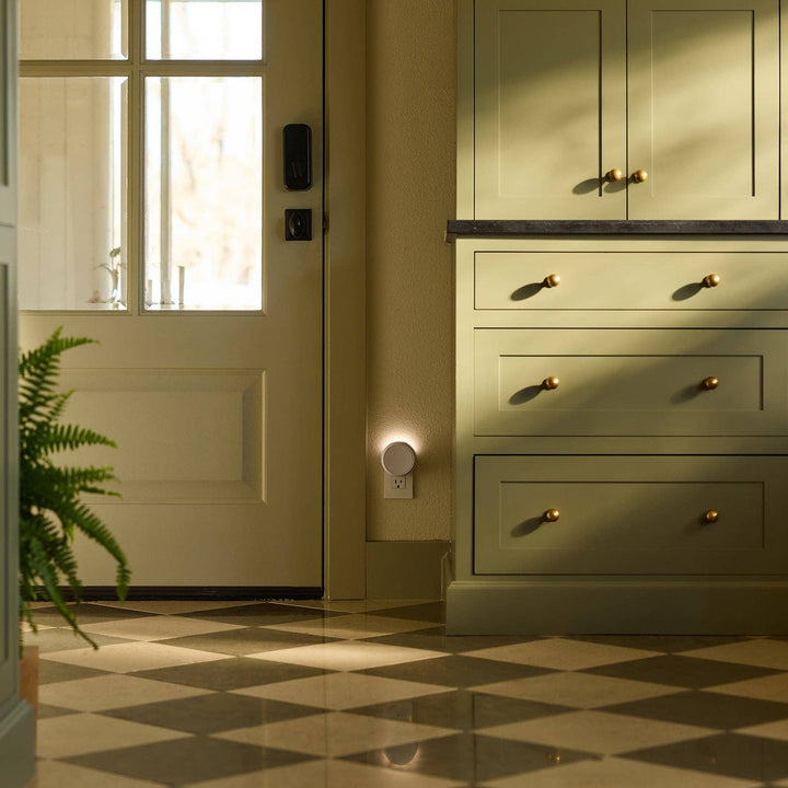 Pura Home plug-in diffuser glowing in a kitchen with green cabinets