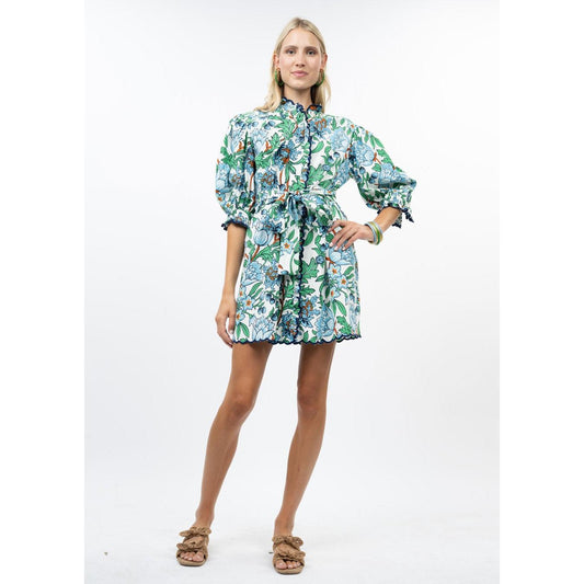 Close-up of the intricate scalloped trim and vibrant blue and green floral fabric on the Uncle Frank dress.