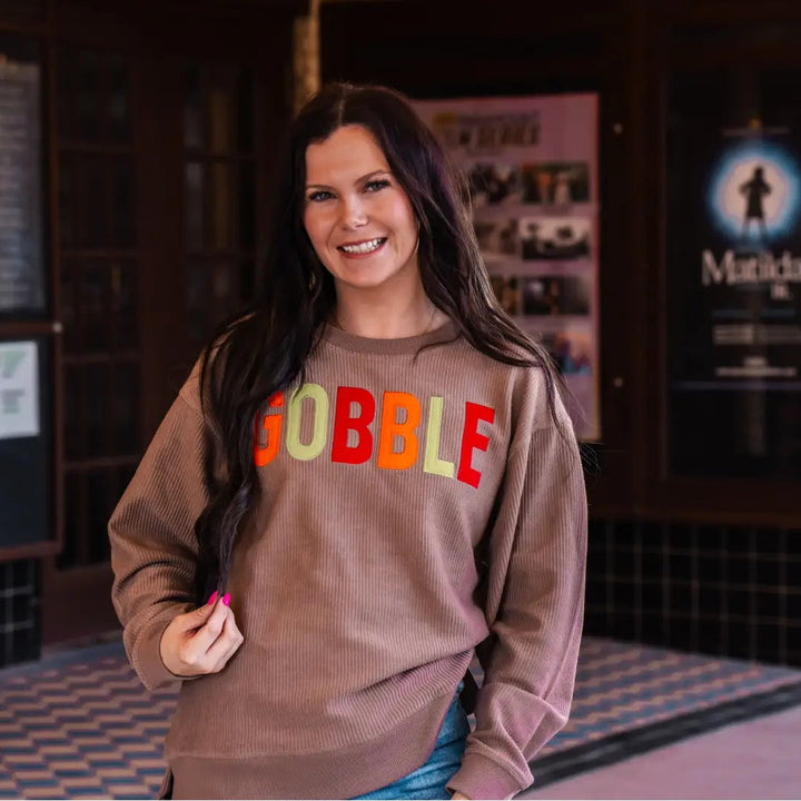 Spirit to a Tee brown cozycord crewneck sweatshirt featuring the word "Gobble" in textured tackle twill lettering.