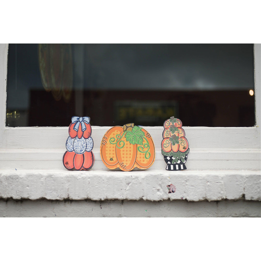 DK Designs Georgia gingham pumpkin mini displayed on a windowsill with stacked pumpkin minis