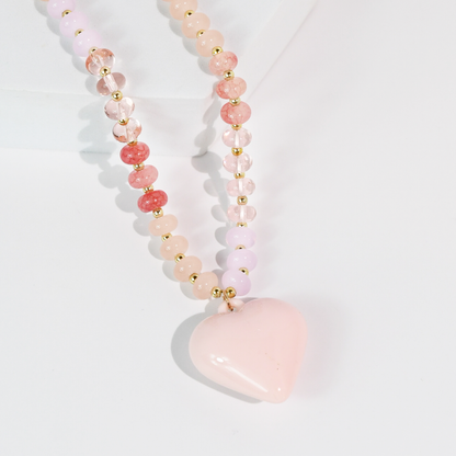 Necklace with pink heart pendant on a light gray background