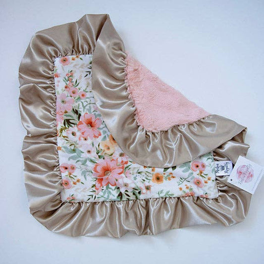Rockin Royalty Juliette Luxe Lovie featuring a pink floral pattern, plush blush fur backing, and a wide satin ruffle trim.