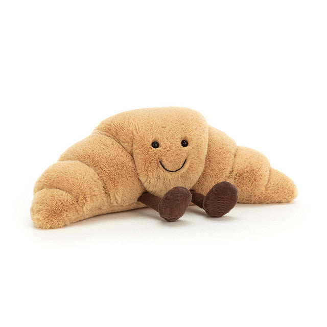 Jellycat Amuseables Croissant Small; golden-brown plush pastry with a smile and brown corduroy feet.