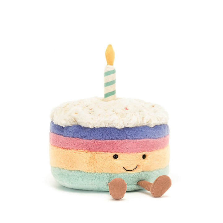 Jellycat Amuseables Rainbow Birthday Cake plush with four colorful layers and a birthday candle.