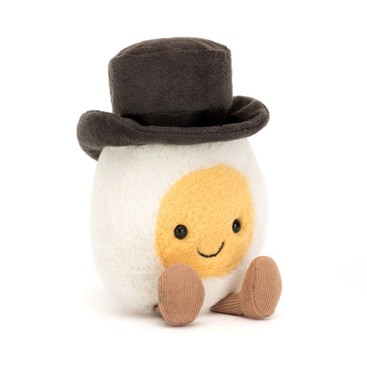 Dapper Jellycat Boiled Egg Groom plush wearing a black bow tie and brown corduroy boots.